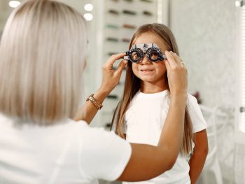child-eye-test-and-eye-exam-little-girl-having-eye-check-up-with-phoropter-doctor-performs-eye-test-for-child